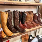 shelf of cowboy boots, western style, some are antiques